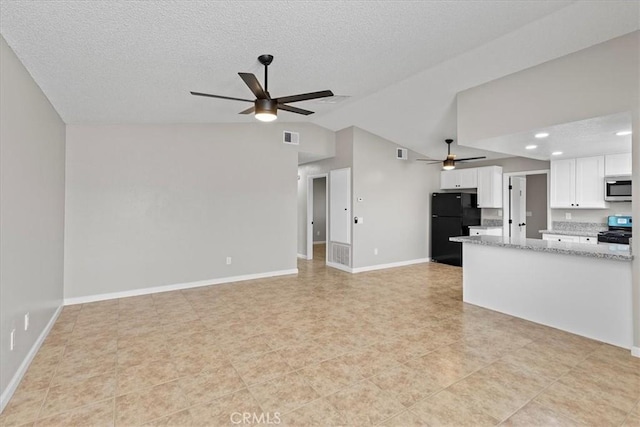 kitchen featuring visible vents, ceiling fan, lofted ceiling, stainless steel appliances, and white cabinetry