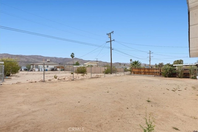 view of yard with a mountain view and fence