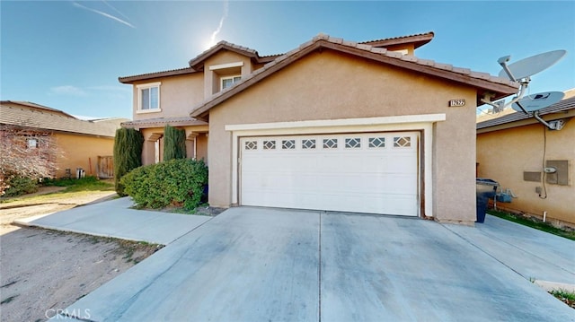 view of front of property featuring stucco siding, an attached garage, and driveway