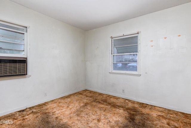 unfurnished room with baseboards