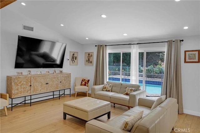 living area featuring light wood finished floors, visible vents, baseboards, vaulted ceiling, and recessed lighting