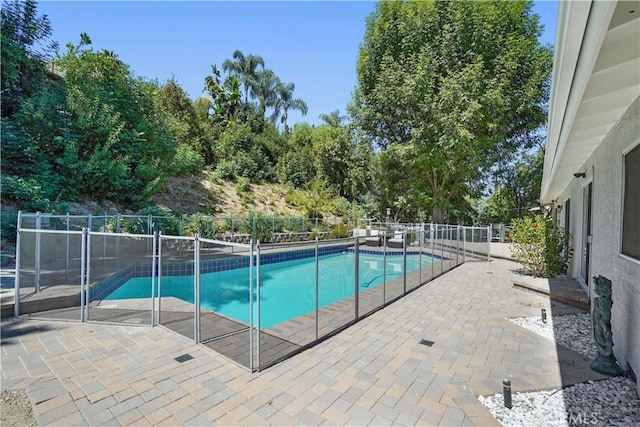 view of pool featuring a patio, fence, and a fenced in pool