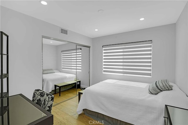 bedroom featuring recessed lighting, light wood-style floors, and visible vents