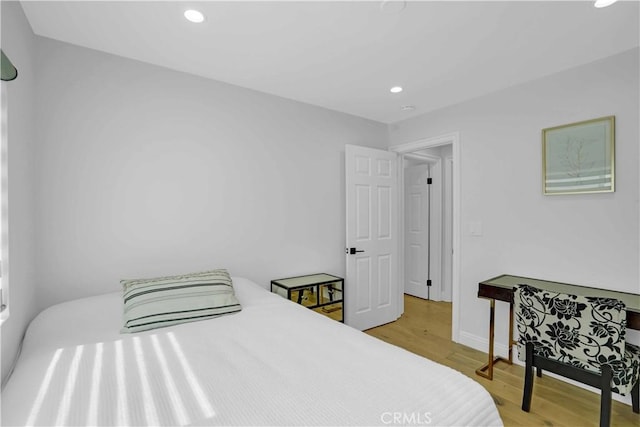 bedroom featuring recessed lighting, light wood-type flooring, and baseboards