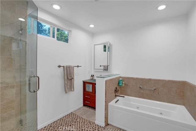 bathroom featuring a bath, a shower stall, and vanity