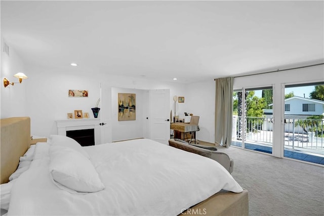 bedroom with recessed lighting, a fireplace, carpet flooring, and access to outside