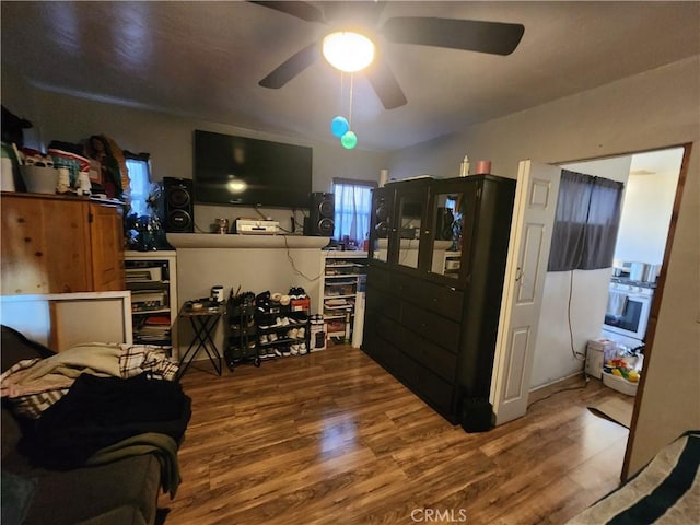 living area featuring wood finished floors and a ceiling fan