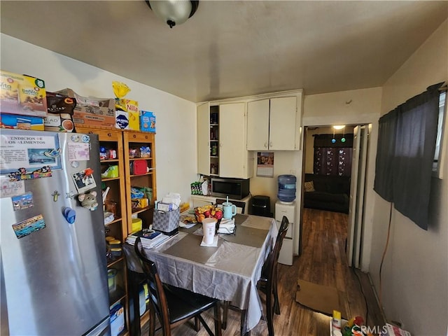 kitchen with white cabinets, stainless steel appliances, and wood finished floors