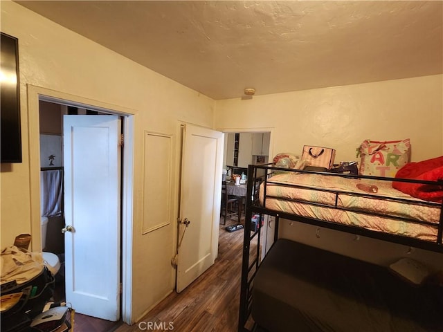 bedroom featuring dark wood-type flooring