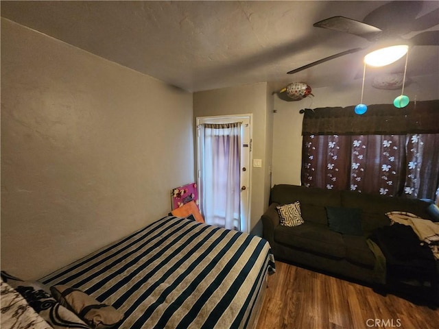 living room with a ceiling fan and wood finished floors