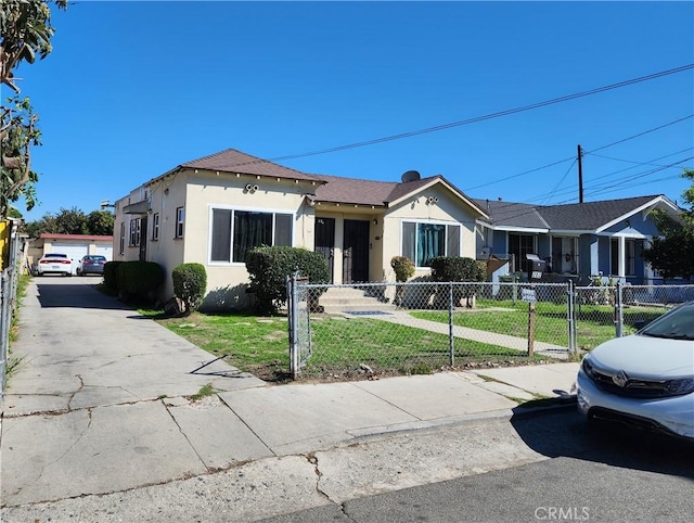 view of front of home with stucco siding, a fenced front yard, and a front yard