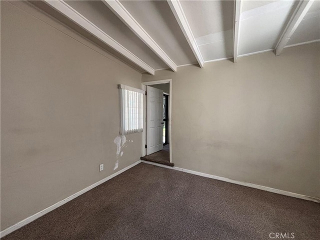 carpeted spare room with beam ceiling and baseboards