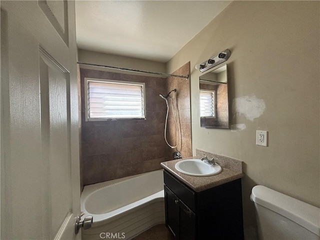 full bath featuring toilet, vanity, and bathing tub / shower combination