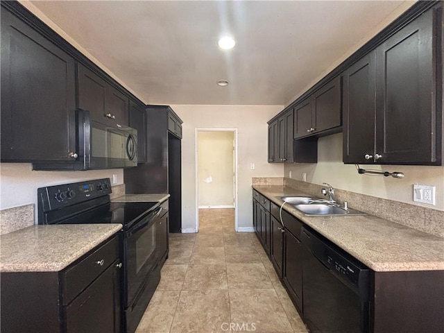 kitchen with a sink, baseboards, black appliances, and light countertops