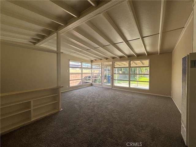 spare room featuring lofted ceiling, carpet flooring, baseboards, and a sunroom