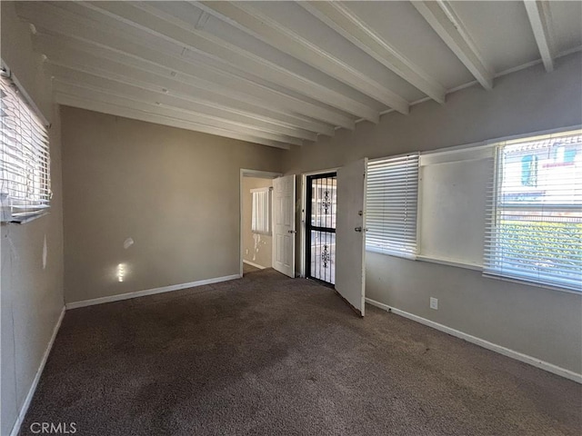 interior space featuring a wealth of natural light, beamed ceiling, and baseboards