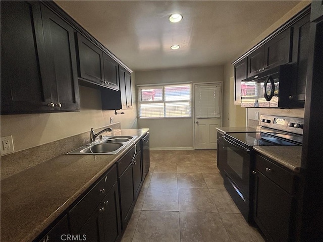 kitchen with tile patterned flooring, black appliances, dark cabinets, and a sink