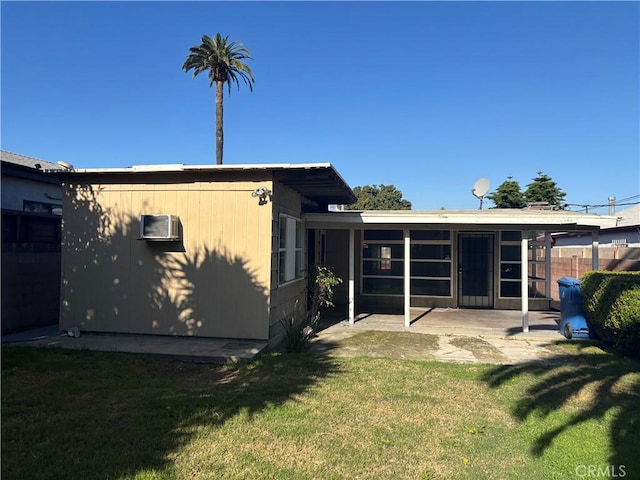 rear view of property with a lawn, a patio, and fence