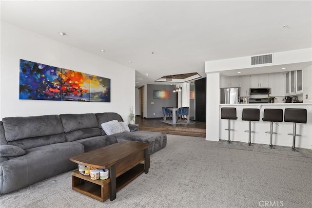 living area with a notable chandelier, visible vents, and recessed lighting