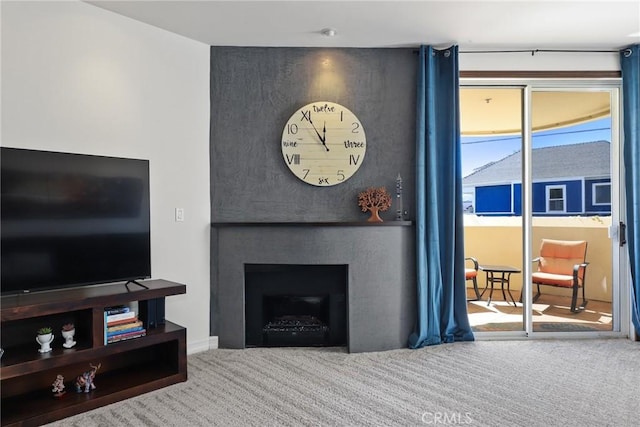 living room with carpet and a fireplace