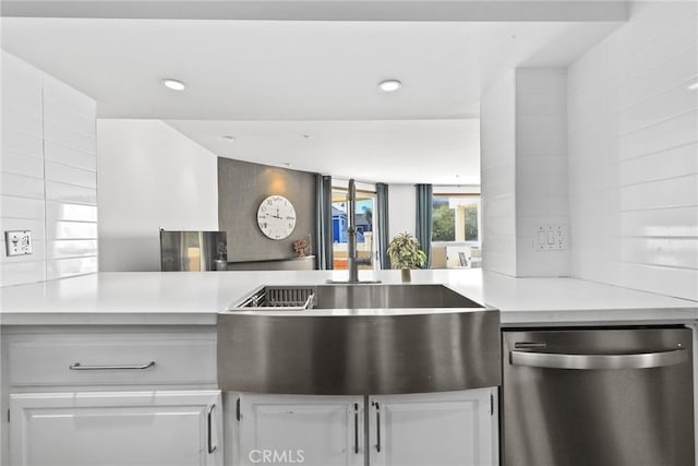 kitchen featuring recessed lighting, white cabinetry, dishwasher, and light countertops