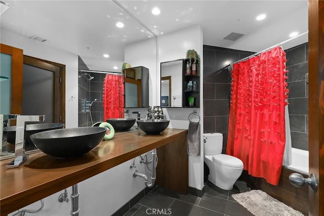 full bathroom featuring tile patterned flooring, visible vents, toilet, and tile walls