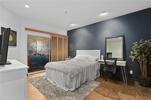 bedroom with recessed lighting and light wood-style flooring