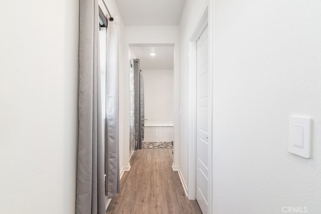 corridor featuring wood finished floors