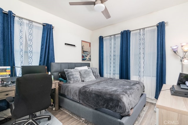 bedroom with a ceiling fan and wood finished floors