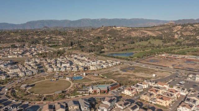 drone / aerial view with a residential view and a water and mountain view