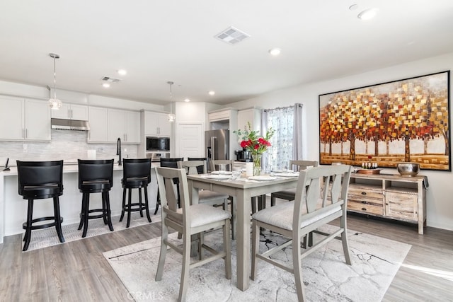 dining room featuring recessed lighting, light wood-style floors, and visible vents