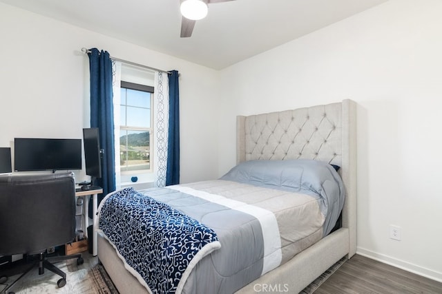 bedroom with ceiling fan, baseboards, and wood finished floors