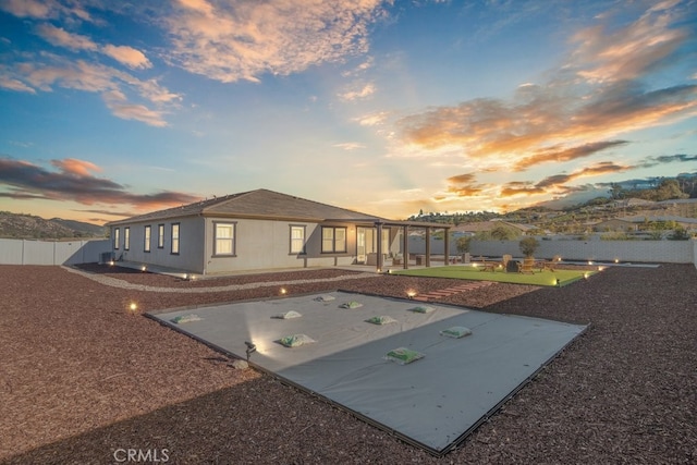 back of property featuring a fenced backyard, a pergola, and a patio