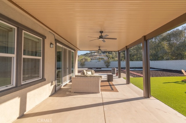 view of patio with a ceiling fan and fence