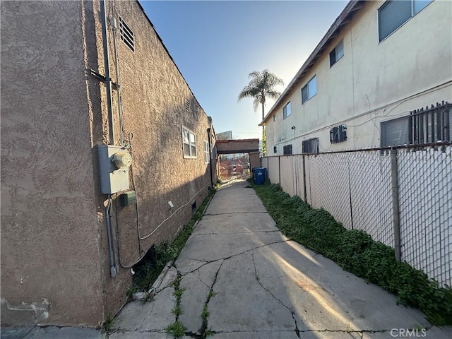 view of property exterior with fence and stucco siding