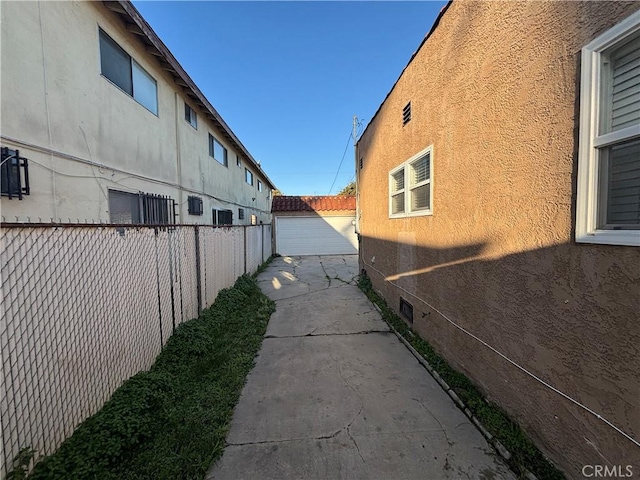 view of property exterior featuring stucco siding and fence