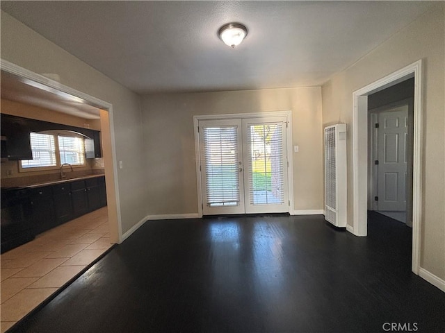 interior space with french doors, baseboards, and wood finished floors