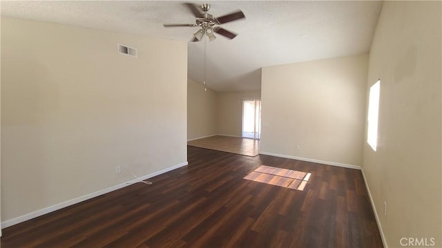 spare room with visible vents, ceiling fan, baseboards, lofted ceiling, and wood finished floors