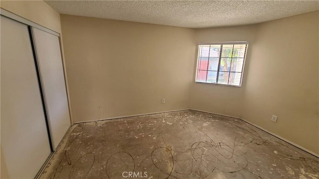 unfurnished bedroom featuring a closet and a textured ceiling