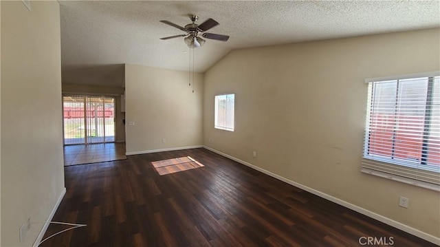 unfurnished room featuring ceiling fan, baseboards, vaulted ceiling, wood finished floors, and a textured ceiling