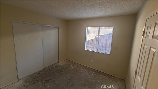 unfurnished bedroom featuring a closet and a textured ceiling