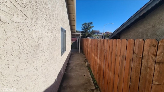 view of property exterior with fence and stucco siding