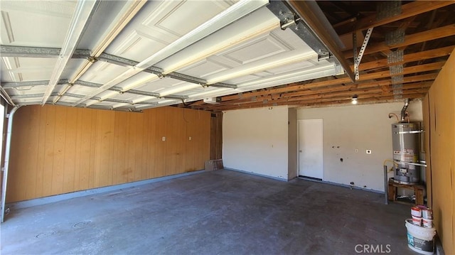 garage with secured water heater and a garage door opener