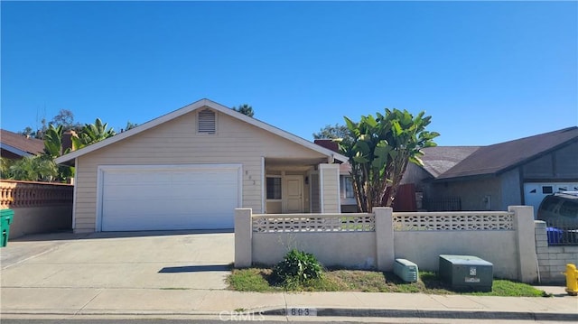 single story home with concrete driveway, an attached garage, and a fenced front yard