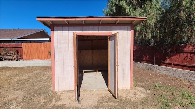 view of shed with a fenced backyard