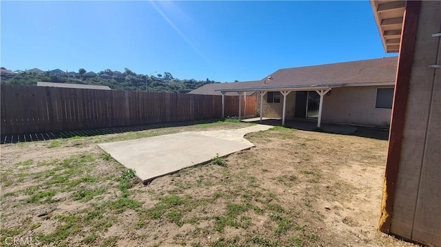 view of yard with a fenced backyard and a patio area