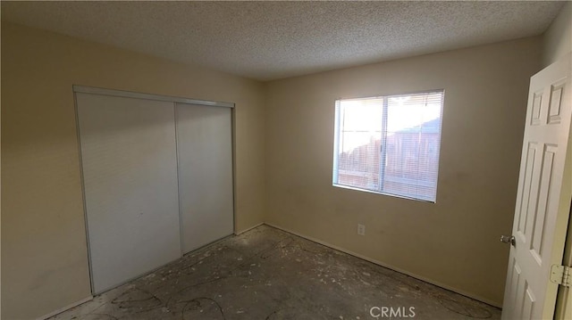 unfurnished bedroom with a closet and a textured ceiling