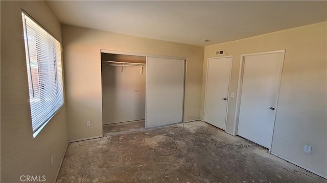 unfurnished bedroom with a closet and visible vents