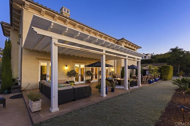 view of patio / terrace with french doors, an outdoor hangout area, and a pergola