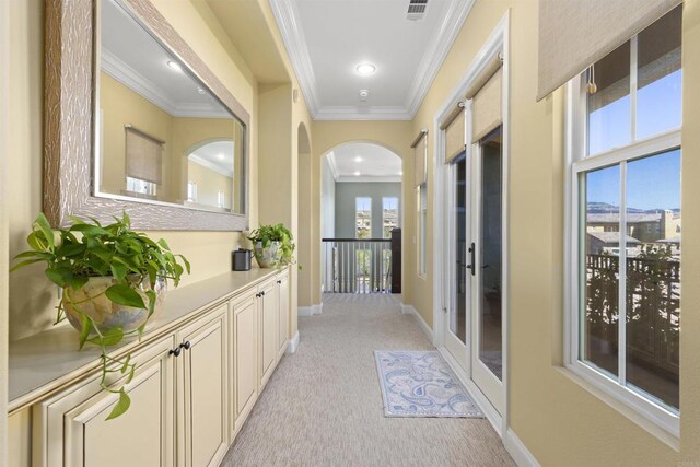 corridor with baseboards, visible vents, recessed lighting, ornamental molding, and light colored carpet